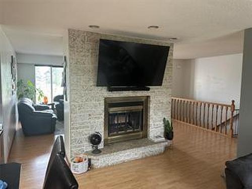 245 Swan River Drive, Swan River, MB - Indoor Photo Showing Living Room With Fireplace