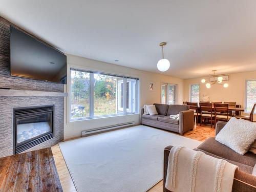 Living room - 600 Ch. Olivier, Saint-Côme, QC - Indoor Photo Showing Living Room With Fireplace