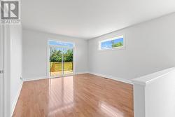 Living room part of grand room with gleaming hardwood floors - 