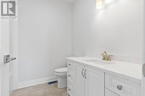 4-piece main floor bathroom with full bathtub & quartz countertops that match those in ensuite bath, lower level bath and kitchen countertops - 9 Billings Avenue W, South Dundas, ON - Indoor Photo Showing Bathroom