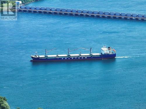 Freighter passing in front of Iroquois damn adjacent to Iroquois locks - 9 Billings Avenue W, South Dundas, ON - Outdoor With Body Of Water With View