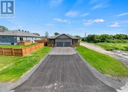 Exterior front with paved driveway. - 