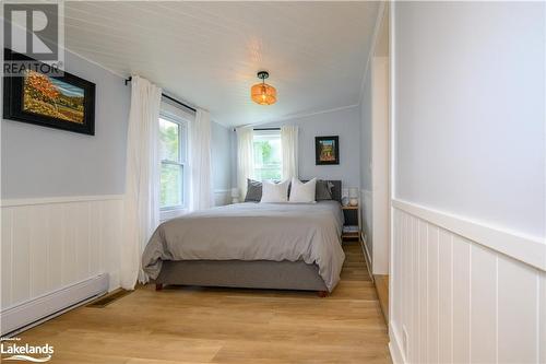 Primary bedroom with lots of natural light. - 185 South Fairy Lake Road, Huntsville, ON - Indoor Photo Showing Bedroom