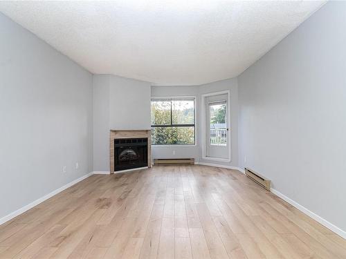 210-2815 Departure Bay Rd, Nanaimo, BC - Indoor Photo Showing Living Room With Fireplace