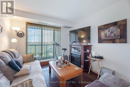 318 - 65 Via Rosedale, Brampton, ON - Indoor Photo Showing Living Room With Fireplace