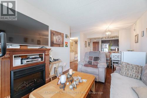 318 - 65 Via Rosedale, Brampton, ON - Indoor Photo Showing Living Room With Fireplace