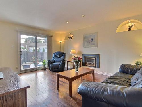 Salle familiale - 3930 Place Miron, Brossard, QC - Indoor Photo Showing Living Room With Fireplace