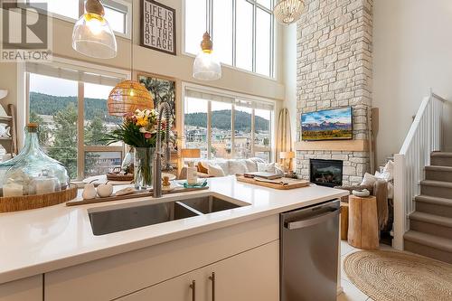 7343 Okanagan Landing Road Unit# 2404, Vernon, BC - Indoor Photo Showing Kitchen With Fireplace With Double Sink