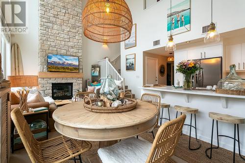 7343 Okanagan Landing Road Unit# 2404, Vernon, BC - Indoor Photo Showing Dining Room With Fireplace