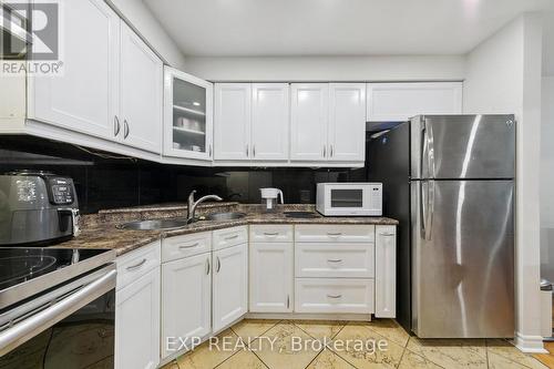 59 - 3025 Cedarglen Gate, Mississauga, ON - Indoor Photo Showing Kitchen With Double Sink