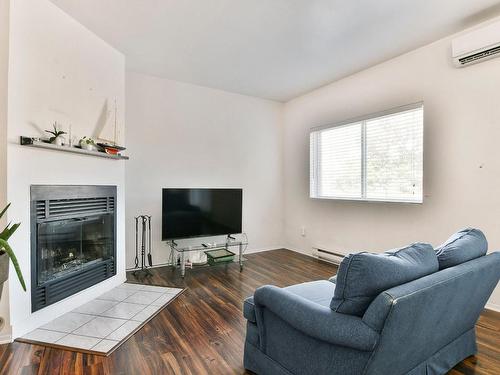 Living room - 5-776 Av. Ampère, Laval (Laval-Des-Rapides), QC - Indoor Photo Showing Living Room With Fireplace