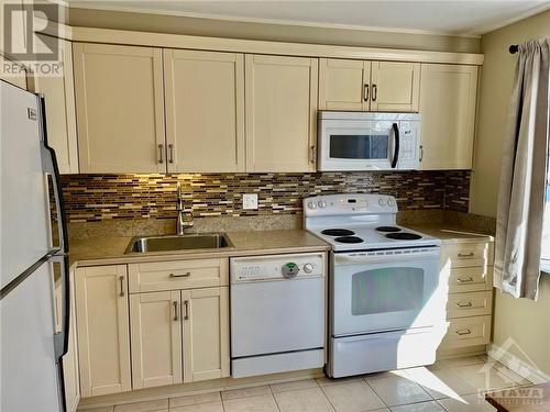 Updated kitchen with Bay window and pass through. Custom wooden island/prep space included. - 2285 Stonehenge Crescent, Ottawa, ON - Indoor Photo Showing Kitchen