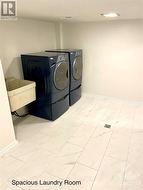 Large tiled laundry area leads to the furnace room and more storage - 