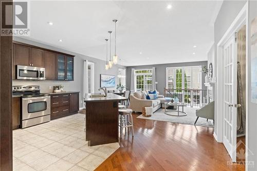 Bright open-concept living space with a modern kitchen island, stainless steel appliances, and large windows that flood the room with natural light. - 316 Eckerson Avenue, Ottawa, ON - Indoor Photo Showing Kitchen With Upgraded Kitchen