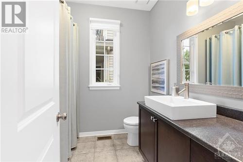 Sleek bathroom with a modern vessel sink, elegant lighting, and soft neutral tones, offering a spa-like feel for a relaxing retreat. - 316 Eckerson Avenue, Ottawa, ON - Indoor Photo Showing Bathroom