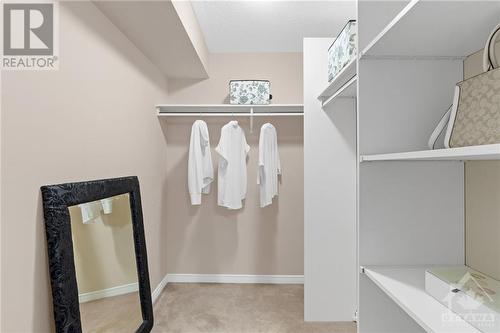 Spacious walk-in closet with ample hanging space and organized shelving, ideal for maximizing storage in a stylish and functional manner. - 316 Eckerson Avenue, Ottawa, ON - Indoor