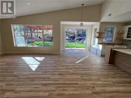 Unfurnished dining area with sink, light hardwood / wood-style flooring, and lofted ceiling - 40 Masson Lane, Callander, ON - Indoor