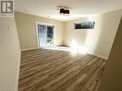 Empty room with light hardwood / wood-style flooring - 