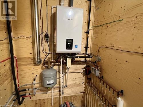 Utilities featuring tankless water heater - 40 Masson Lane, Callander, ON - Indoor Photo Showing Basement