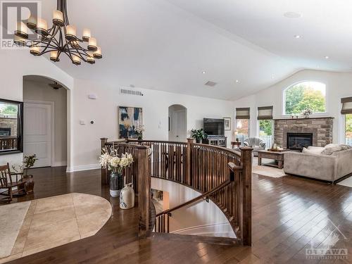 Wonderful living space, so bright and airy. Note the first arched entranceway leads to the main 4 piece bath, laundry rm & garage access.  The secondy leads to the primary bedroom and linen closet. - 50 Frances Colbert Avenue, Ottawa, ON - Indoor Photo Showing Other Room With Fireplace