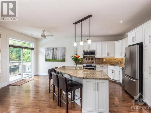 This huge island will serve you well for everyday meals and all your family gatherings.  Note there is space for a dinette set if you prefer a table. - 50 Frances Colbert Avenue, Ottawa, ON - Indoor Photo Showing Kitchen With Upgraded Kitchen