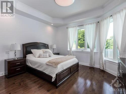 Beautiful Primary Bedroom with coffered ceiling overlooking the backyard, walk-in closet and luxurious 5 piece ensuite. - 50 Frances Colbert Avenue, Ottawa, ON - Indoor Photo Showing Bedroom