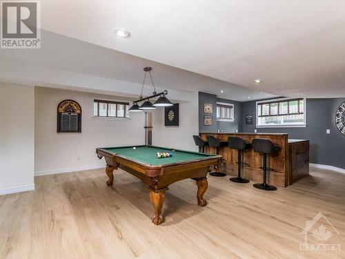 Beautiful Rec Room, perfect size for a pool table, complete with wet bar. Note the lovely new deluxe vinyl flooring. There is also a set of stairs at the back far left that lead to the garage. - 50 Frances Colbert Avenue, Ottawa, ON - Indoor Photo Showing Other Room