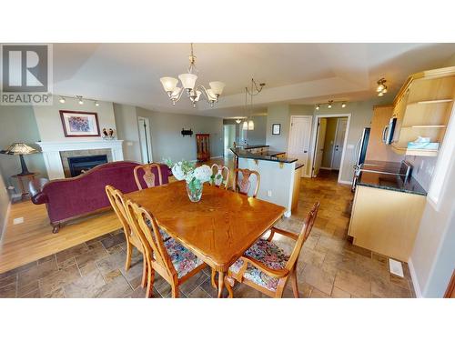 1401 30Th  N Avenue Unit# 27, Cranbrook, BC - Indoor Photo Showing Dining Room With Fireplace