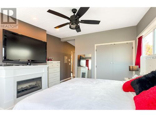 265 Gemini Road, Kelowna, BC - Indoor Photo Showing Bedroom With Fireplace