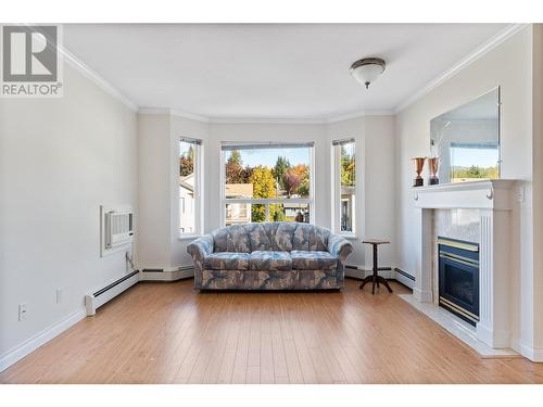 250 5 Street Se Unit# 307, Salmon Arm, BC - Indoor Photo Showing Living Room With Fireplace