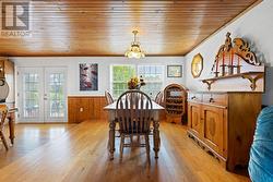 Dining room with huge west-facing windows.  Kitchen is to left. - 