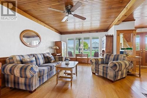 Living room - Note the majority of all main level flooring is hardwood, installed in the late 80s/early 90s.  The only close neighbour's home is seen the window, it has been meticulously renovated - 2176 County Road 22 Road, Cardinal, ON - Indoor Photo Showing Living Room