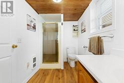 Main level laundry room & 3-piece bathroom with hi-end modern flooring.  Expertly renovated. - 