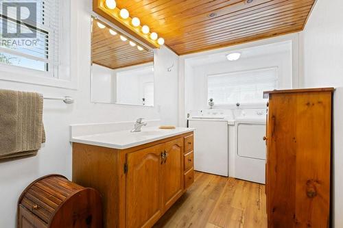 Laundry area, part of main level 3-piece bathroom.   Note gorgeous vanity & big/bright window above washer and dryer. - 2176 County Road 22 Road, Cardinal, ON - Indoor Photo Showing Laundry Room