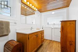 Laundry area, part of main level 3-piece bathroom.   Note gorgeous vanity & big/bright window above washer and dryer. - 