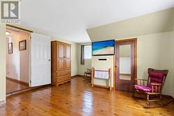 Primary bedroom with 1 east facing window & 1 south facing window & huge walk-in closet which is included in overall room measurement. - 