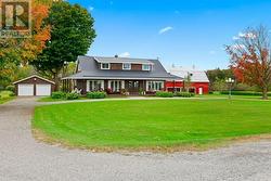 Exterior front showing both large garage & barn/storage building.   Yes, great curb appeal.  Come for a look, you will be impressed! - 