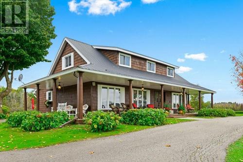 Exterior front showing huge wrap around covered veranda on 3 sides of awesome home-  Kick back & watch the awesome country sunrises. - 2176 County Road 22 Road, Cardinal, ON - Outdoor With Deck Patio Veranda