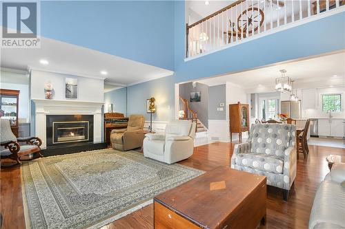 The living room has a gas fireplace to make your days or nights even cosier. The open loft above allows the sun to fill the room as well - 8 Spyglass Ridge, Stittsville, ON - Indoor Photo Showing Living Room With Fireplace