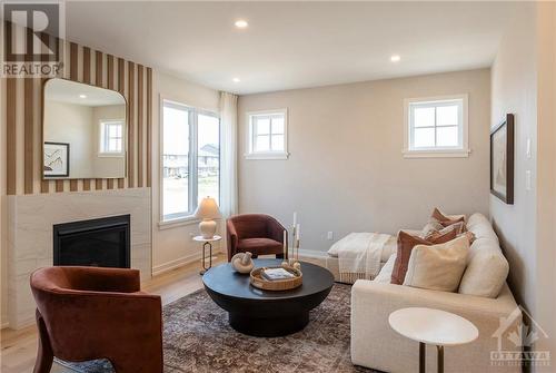 Family Room of similar decorated model - 783 Kenny Gordon Avenue, Ottawa, ON - Indoor Photo Showing Living Room With Fireplace