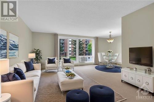 Please note this photo is digitally staged - 1485 Baseline Road Unit#210, Ottawa, ON - Indoor Photo Showing Living Room