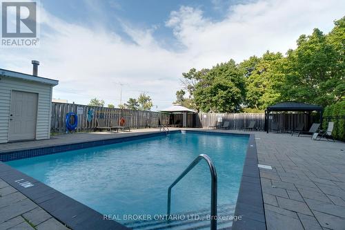 109 - 700 Dynes Road, Burlington, ON - Outdoor With In Ground Pool