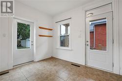 Kitchen features a door to back yard and deck, and a side door to covered porch. - 