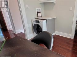 Laundry area with combo washer/dryer is within the office room - 