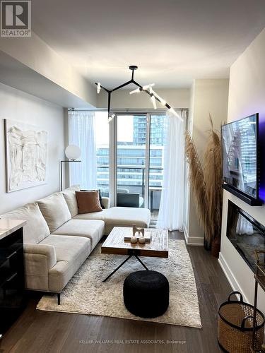 1706 - 20 Shore Breeze Drive, Toronto, ON - Indoor Photo Showing Living Room With Fireplace