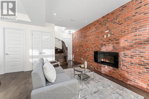 36 - 8169 Kipling Avenue, Vaughan, ON - Indoor Photo Showing Living Room With Fireplace