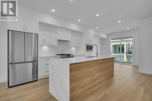 Modern two-tone kitchen - 5300 Main Street Unit# 120, Kelowna, BC - Indoor Photo Showing Kitchen With Upgraded Kitchen