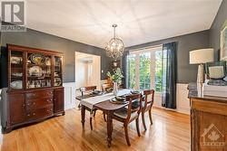 Dining room featuring wainscoting and oak hardwood flooring - 