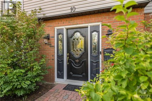 Private front door entrance featuring interlock walkway and plenty of greenery for privacy. - 10 Riverbrook Road, Ottawa, ON - Outdoor