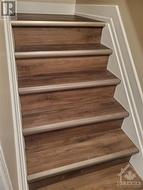 Stairs to lower level with newly installed high-end vinyl. - 